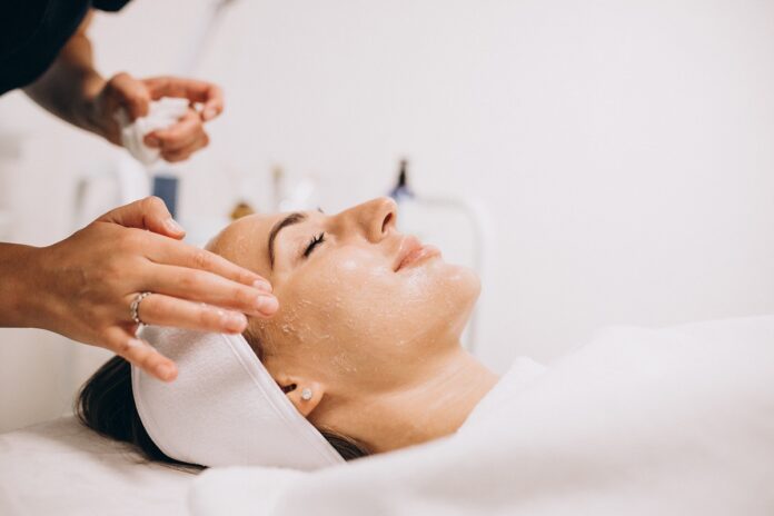 Cosmetologist applying product on woman’s face